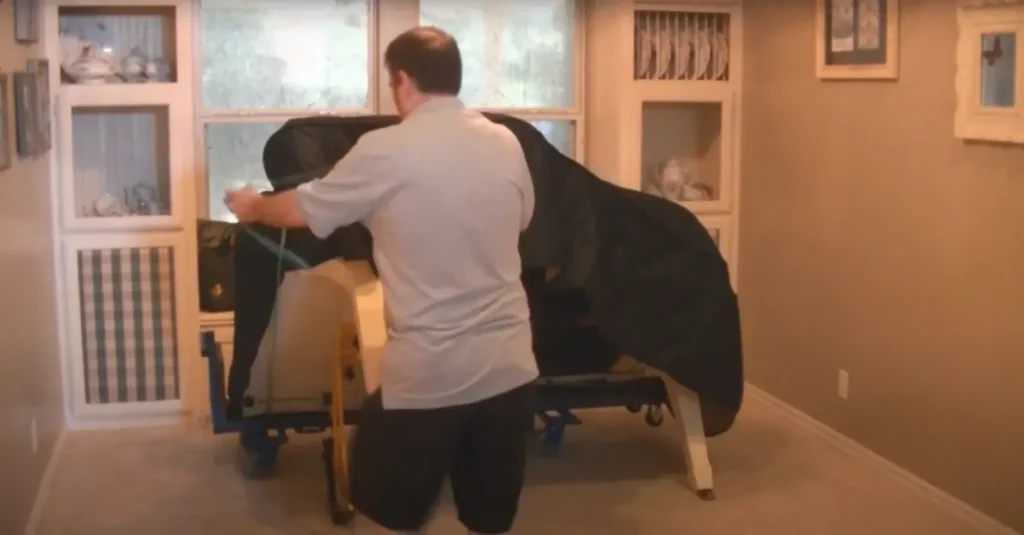 Apartment Movers 15 Mover padding an upright piano on a dolly