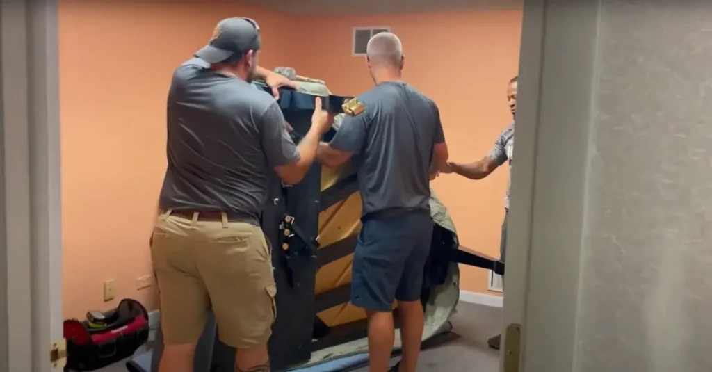 Apartment Movers 16 Crew guiding a piano through a narrow doorway
