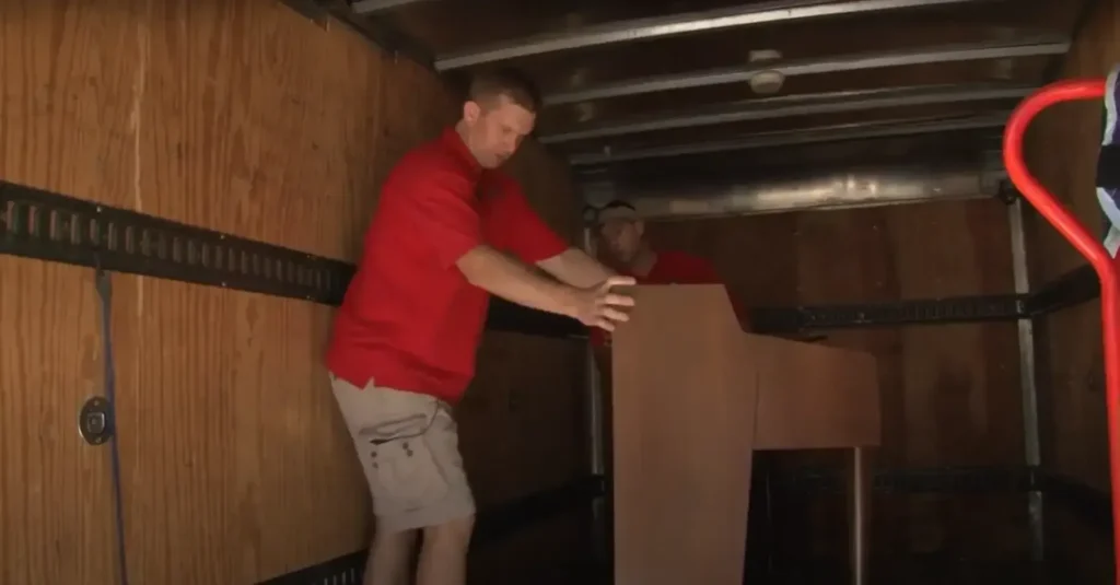 Apartment Movers 14 Mover pushing a wardrobe deeper into the box truck